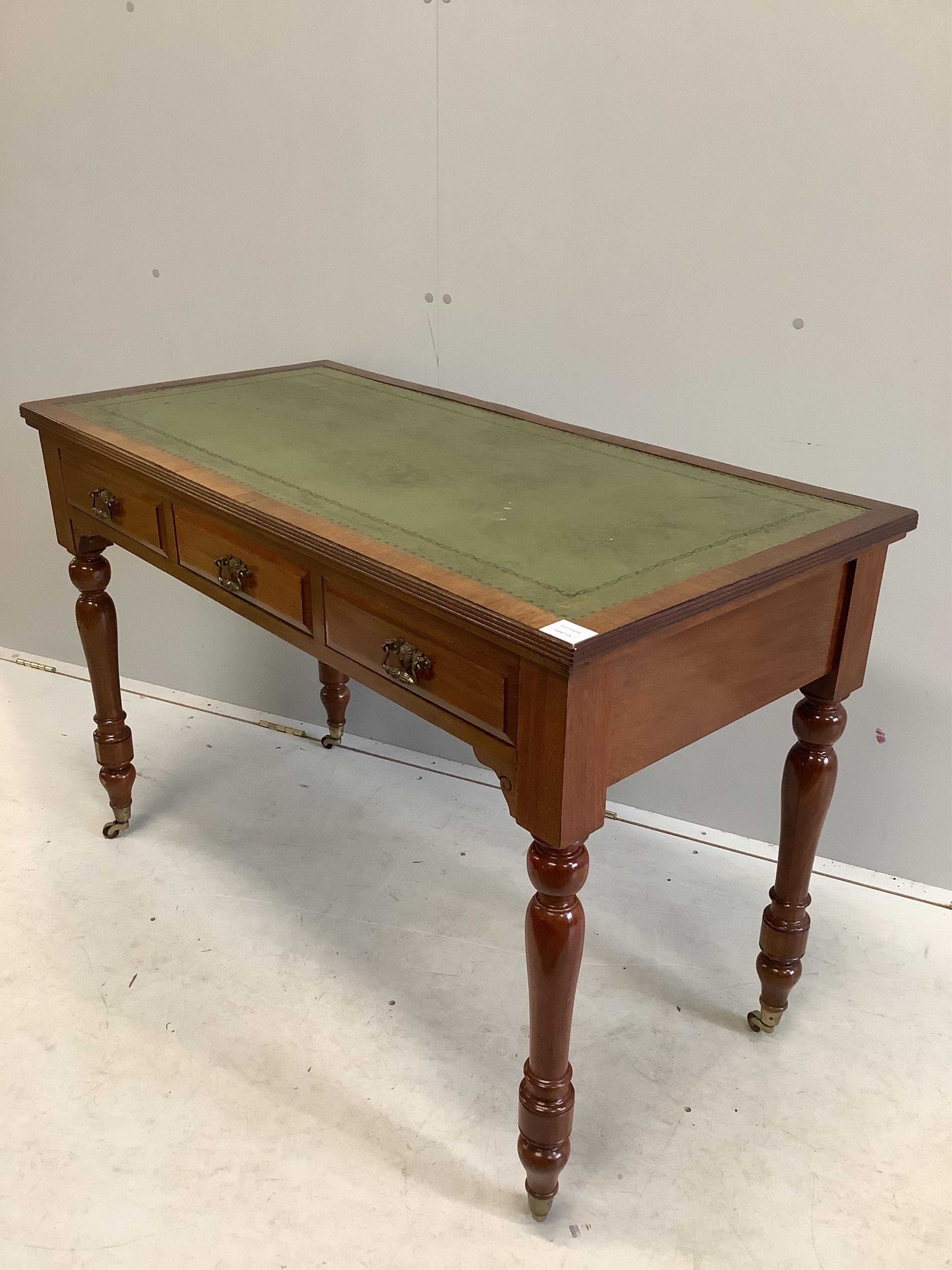 A late Victorian mahogany three drawer writing table, with an inset leather top, width 113cm, depth 55cm, height 77cm. Condition - fair to good, one piece of veneer detached but present